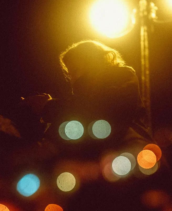 Person at night with city lights